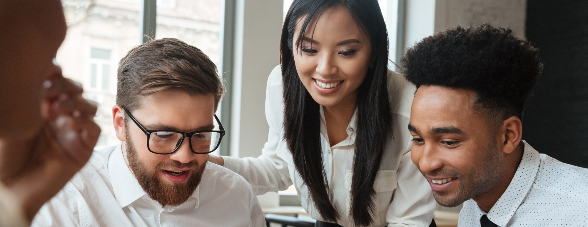 3 people looking at laptop