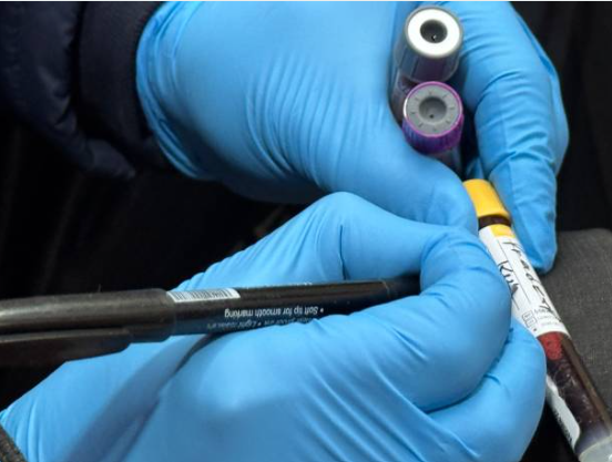 Phlebotomist Holding Test Tubes